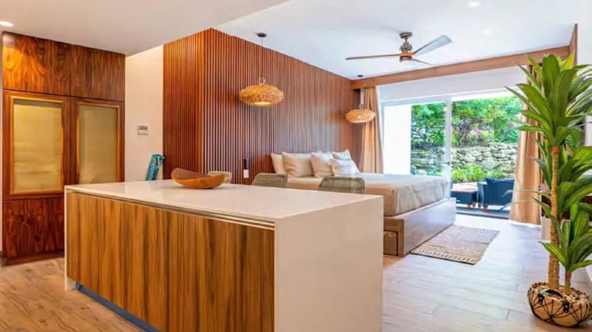 una cocina elegante con una recamara y un balcon al fondo en the leaf condos playacar