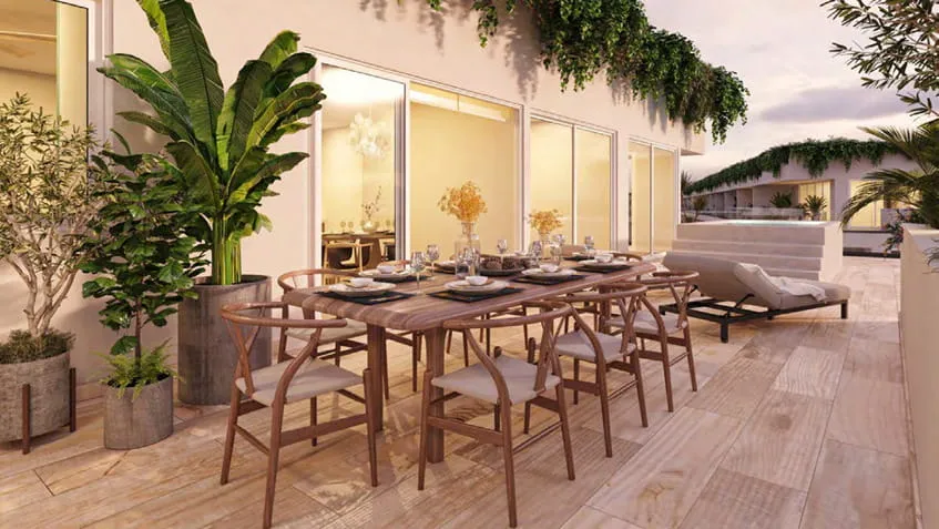 una terraza con un comedor para varias personas en the leaf condos playacar