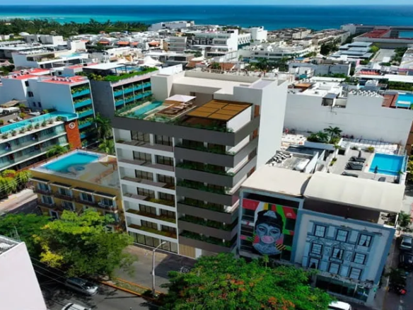 una vista aerea de un edificio nuevo de departamentos en distrito playa playa del carmen