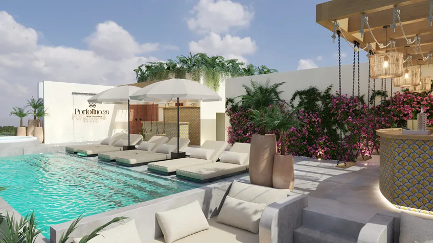 una alberca con camastros alrededor en portofino 28 playa del carmen