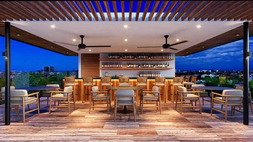 una terraza con un bar en maresol playa estudios