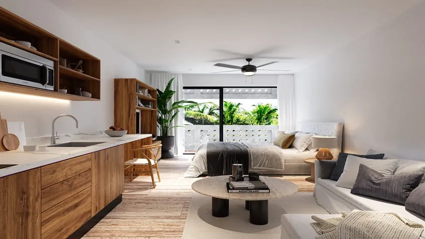 una cocina moderna y una cama al lado en maresol playa estudios