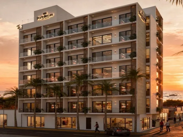 una fachada al atardecer de un edificio nuevo de departamentos en portofino 28 playa del carmen